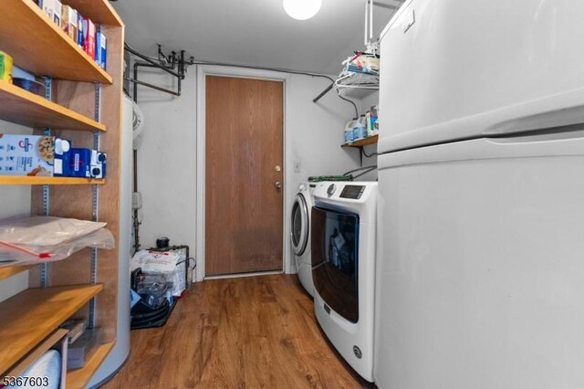 26 Ditmars Cir, Hillsborough Twp, NJ 08844 - laundry room with washing machine and clothes dryer and wood finished floors