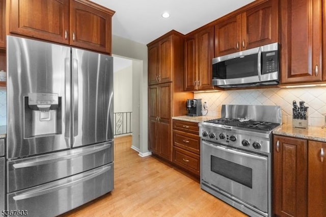 26 Ditmars Cir, Hillsborough Twp, NJ 08844 - kitchen with appliances with stainless steel finishes, light stone countertops, light wood-style floors, backsplash, and recessed lighting