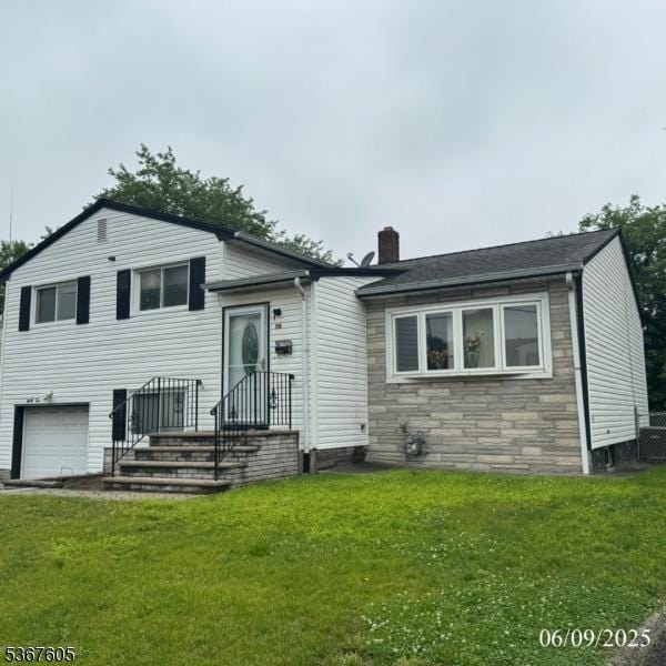35 Eastern Pkwy, Hillside Twp, NJ 07205 - split level home with a chimney, an attached garage, stone siding, and a front lawn