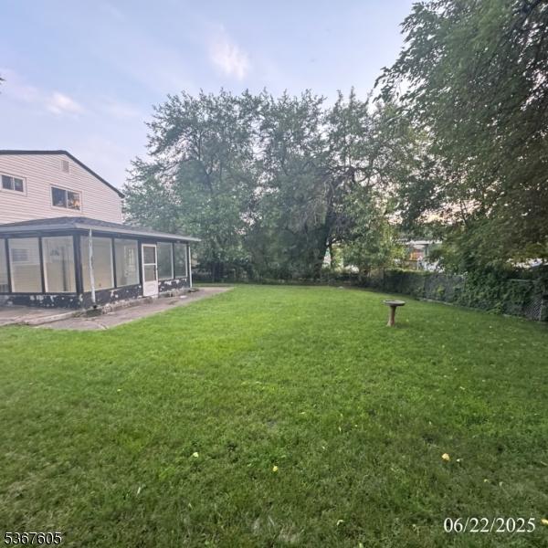 35 Eastern Pkwy, Hillside Twp, NJ 07205 - view of grassy yard featuring a sunroom