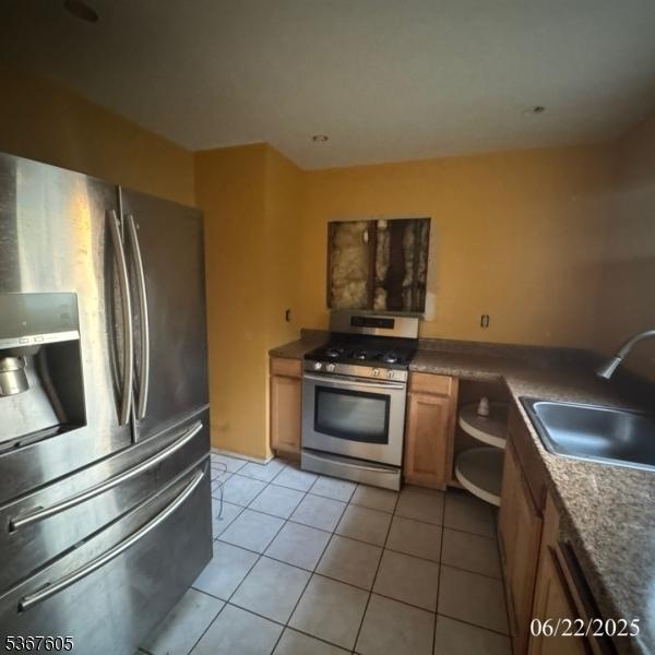 35 Eastern Pkwy, Hillside Twp, NJ 07205 - kitchen featuring appliances with stainless steel finishes and light tile patterned floors