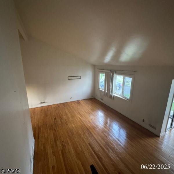 35 Eastern Pkwy, Hillside Twp, NJ 07205 - empty room with wood finished floors and lofted ceiling
