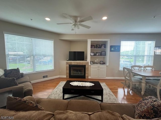 1002 Deerhaven Ter, Lopatcong Twp, NJ 08886 - living area with healthy amount of natural light, ceiling fan, a tile fireplace, recessed lighting, and light wood-style floors