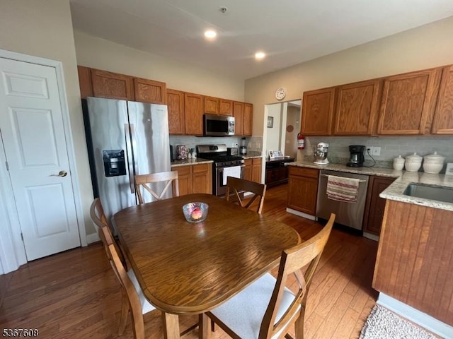 1002 Deerhaven Ter, Lopatcong Twp, NJ 08886 - kitchen with appliances with stainless steel finishes, hardwood / wood-style flooring, brown cabinetry, backsplash, and recessed lighting