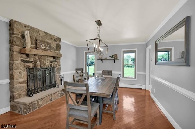 1508 County Rd 565, Vernon Twp, NJ 07461 - dining area featuring a baseboard radiator, wood finished floors, a stone fireplace, and crown molding