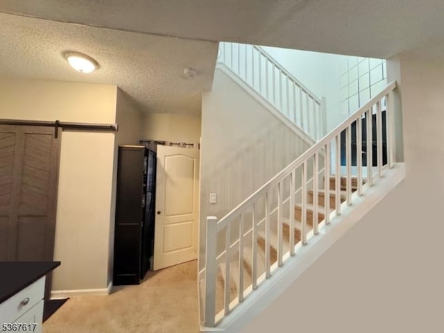 8619 Brittany Dr, Wayne Twp, NJ 07470 - staircase featuring carpet flooring, a barn door, and a textured ceiling
