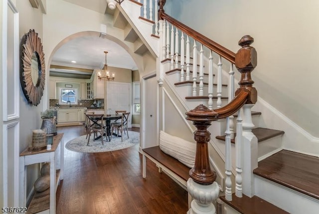 36 E Grant Ave, Roselle Park Boro, NJ 07204 - stairway featuring arched walkways, wood finished floors, ornamental molding, and a chandelier