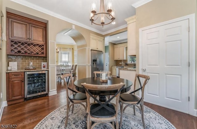 36 E Grant Ave, Roselle Park Boro, NJ 07204 - dining space featuring beverage cooler, arched walkways, a bar, dark wood-style floors, and crown molding