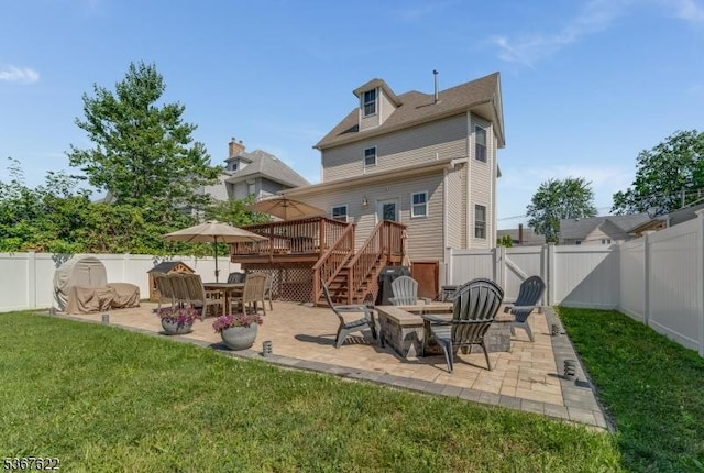36 E Grant Ave, Roselle Park Boro, NJ 07204 - back of property featuring a fenced backyard, a wooden deck, an outdoor fire pit, and a patio