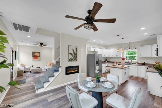 2 Sefel Ave, Plumsted Twp, NJ 08514 - dining space featuring ceiling fan, dark wood finished floors, stairs, recessed lighting, and a glass covered fireplace
