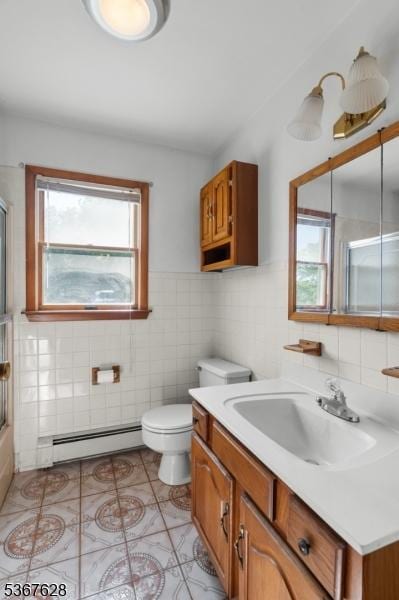 150 Buckley Ave, Oxford Twp, NJ 07863 - bathroom featuring a baseboard heating unit, tile walls, vanity, tile patterned flooring, and wainscoting