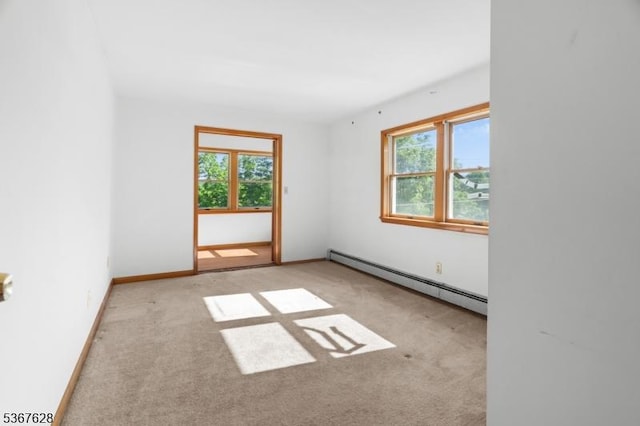 150 Buckley Ave, Oxford Twp, NJ 07863 - empty room with a baseboard heating unit, plenty of natural light, and carpet floors