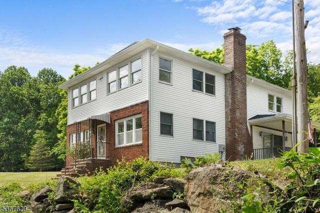 150 Buckley Ave, Oxford Twp, NJ 07863 - rear view of house with a chimney and brick siding