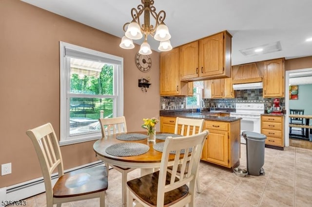 2 Angus Ln, Blairstown Twp, NJ 07825 - kitchen with under cabinet range hood, electric stove, dark countertops, backsplash, and a chandelier