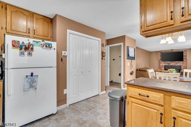 2 Angus Ln, Blairstown Twp, NJ 07825 - kitchen with freestanding refrigerator, a brick fireplace, dark countertops, open floor plan, and light floors