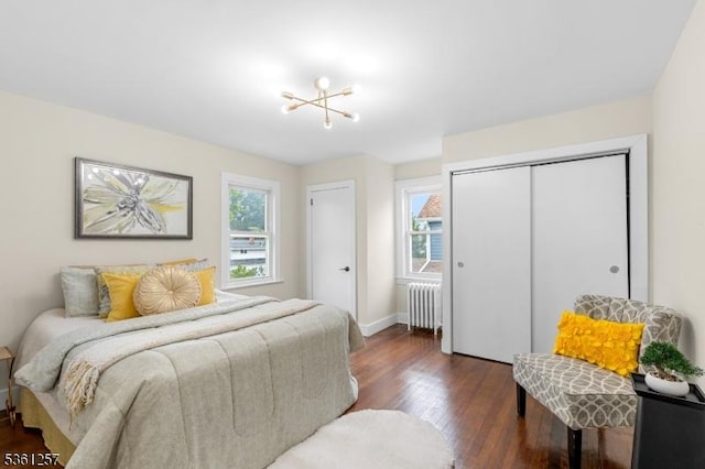 910 Caldwell Ave, Union Twp, NJ 07083 - bedroom with radiator heating unit, multiple windows, dark wood-style flooring, and two closets