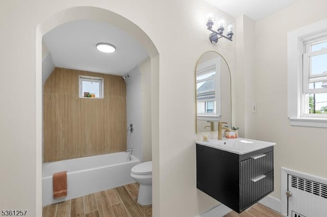 910 Caldwell Ave, Union Twp, NJ 07083 - bathroom with radiator heating unit, vanity, wood finished floors, and tub / shower combination