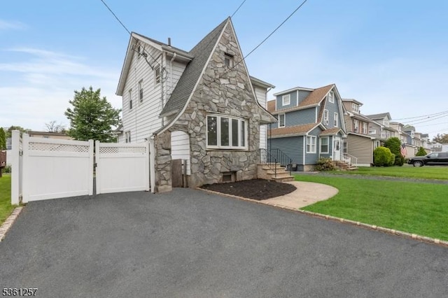 910 Caldwell Ave, Union Twp, NJ 07083 - view of side of property featuring stone siding, a residential view, and a gate