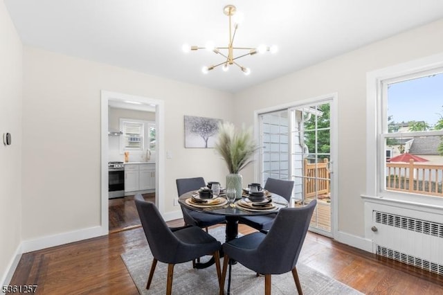 910 Caldwell Ave, Union Twp, NJ 07083 - dining area with radiator heating unit, a chandelier, and wood finished floors