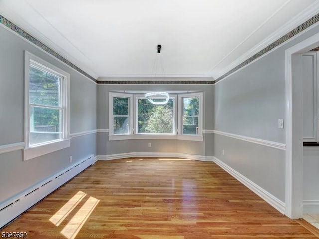 3 Cross Brook Dr, Tewksbury Twp, NJ 07830 - spare room featuring a baseboard heating unit, light wood-style flooring, ornamental molding, and a chandelier