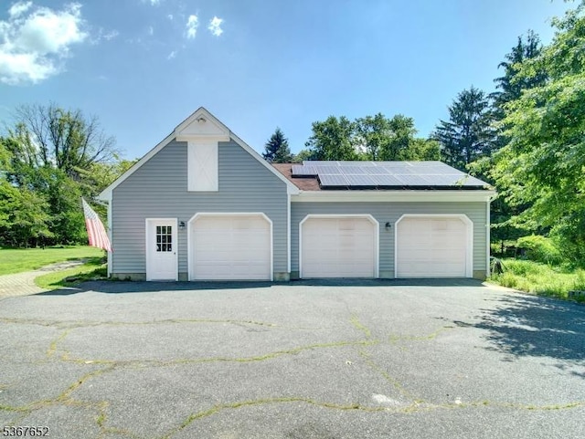3 Cross Brook Dr, Tewksbury Twp, NJ 07830 - garage featuring roof mounted solar panels and driveway