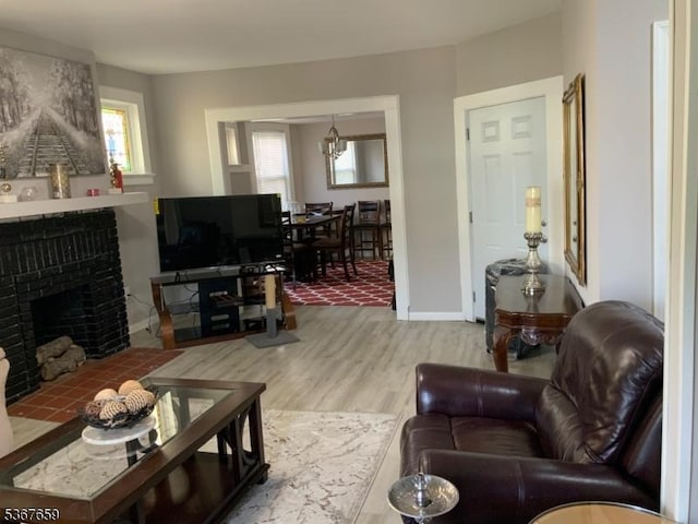 116 Mapes Ave Unit 3, Newark City, NJ 07112 - living area with wood finished floors, a brick fireplace, and a chandelier