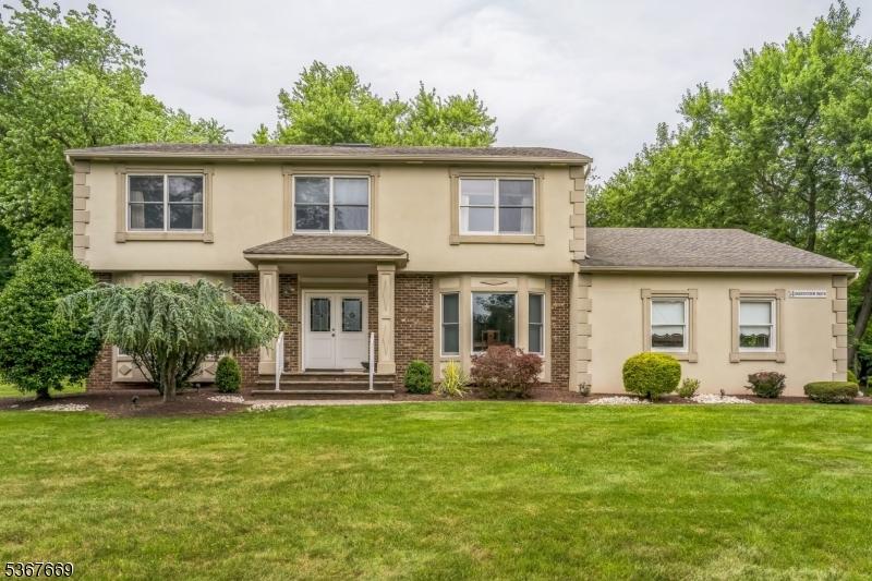 14 Greensview Dr, Scotch Plains Twp, NJ 07076 - view of front facade with stucco siding, a front lawn, french doors, and brick siding