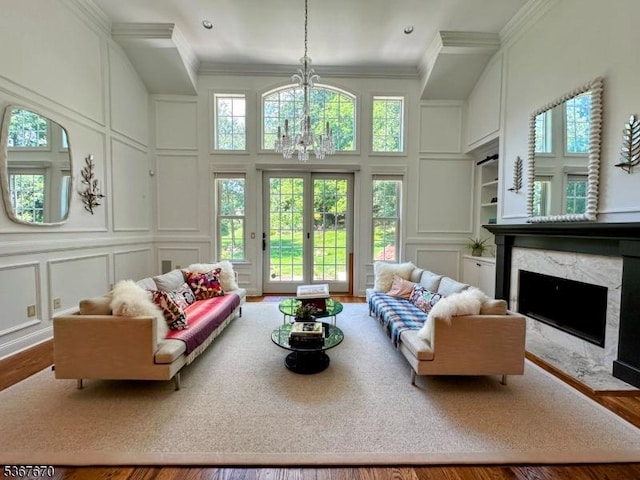 15 Poplar Ln, Chatham Twp, NJ 07928 - living room featuring a decorative wall, a fireplace, ornamental molding, a chandelier, and wood finished floors