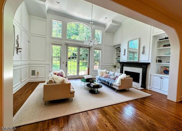15 Poplar Ln, Chatham Twp, NJ 07928 - living area featuring a decorative wall, built in features, ornamental molding, a fireplace, and wood finished floors