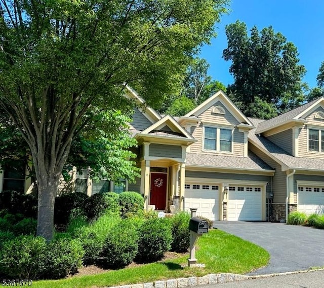 15 Poplar Ln, Chatham Twp, NJ 07928 - view of front of property featuring asphalt driveway, roof with shingles, stone siding, and a garage