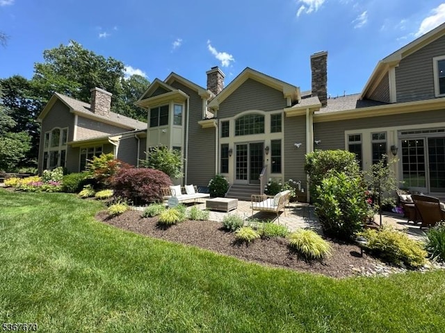 15 Poplar Ln, Chatham Twp, NJ 07928 - rear view of house featuring a patio, a lawn, french doors, and a chimney