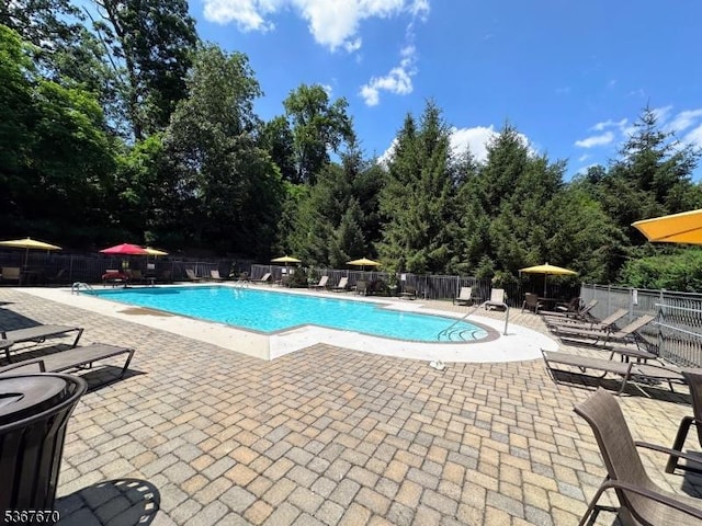 15 Poplar Ln, Chatham Twp, NJ 07928 - community pool with a patio area and view of wooded area