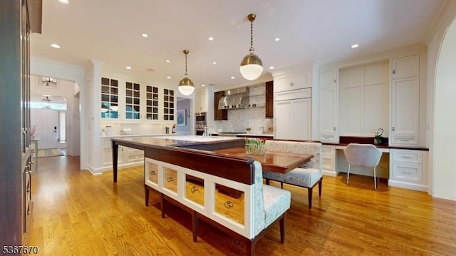 15 Poplar Ln, Chatham Twp, NJ 07928 - kitchen featuring white cabinetry, exhaust hood, glass insert cabinets, decorative backsplash, and hanging light fixtures