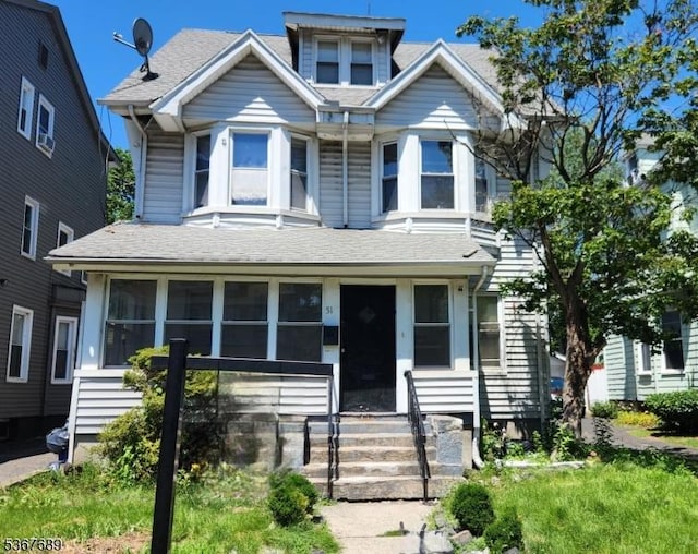 51 Stockton Pl, East Orange City, NJ 07017 - view of front of house with a sunroom, roof with shingles, and entry steps
