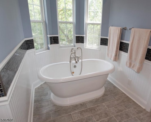 425 Diablo Ct, Mahwah Twp, NJ 07430 - full bathroom with a wainscoted wall, a soaking tub, tile patterned floors, and a decorative wall
