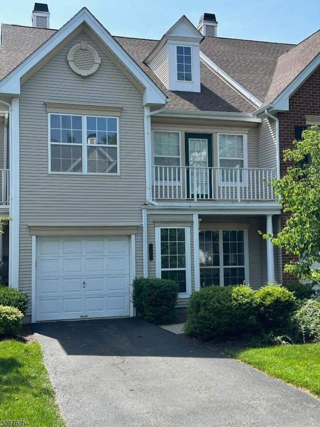 1002 Timberbrooke Dr, Bedminster Twp, NJ 07921 - view of front of home featuring a chimney, driveway, a shingled roof, a garage, and a balcony