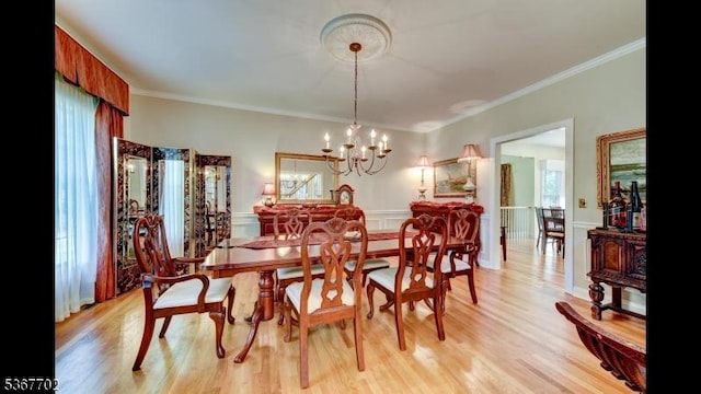 4 Lindsay Ln, Sparta Twp, NJ 07871 - dining space with crown molding, light wood-style floors, a chandelier, and wainscoting