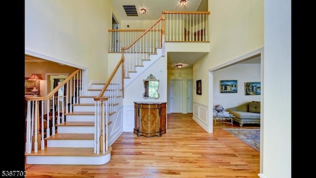 4 Lindsay Ln, Sparta Twp, NJ 07871 - stairs featuring a high ceiling, wood finished floors, and wainscoting