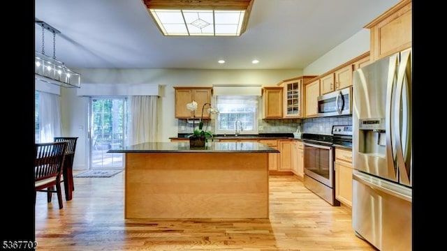 4 Lindsay Ln, Sparta Twp, NJ 07871 - kitchen with stainless steel appliances, dark countertops, light wood finished floors, recessed lighting, and a center island