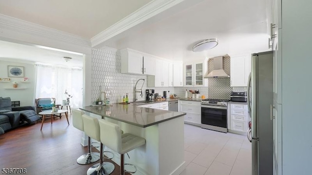 114 Oakley St, Roselle Boro, NJ 07203 - kitchen with appliances with stainless steel finishes, a peninsula, wall chimney exhaust hood, ornamental molding, and a kitchen breakfast bar
