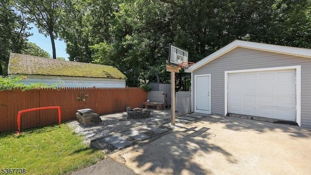 114 Oakley St, Roselle Boro, NJ 07203 - view of patio with an outbuilding, concrete driveway, and a garage