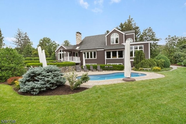 52 W Main St, Mendham Boro, NJ 07945 - rear view of property with a lawn, an outdoor pool, a chimney, and a patio