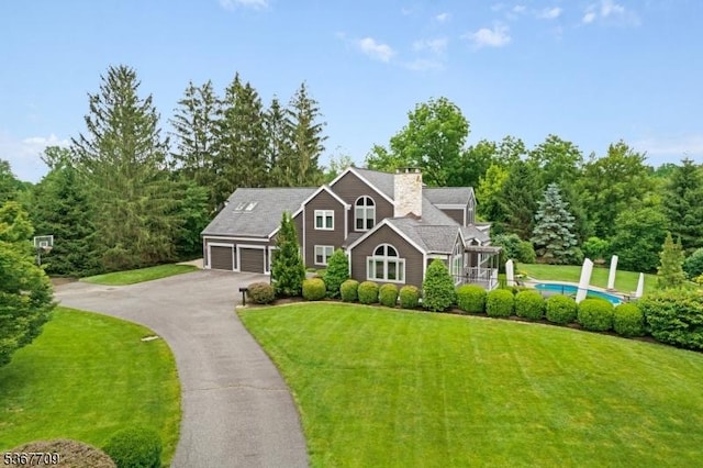 52 W Main St, Mendham Boro, NJ 07945 - view of front of property with asphalt driveway, a front lawn, a garage, and a chimney