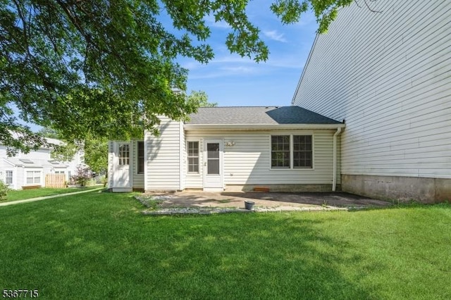 255 Glastonbury Ln, Franklin Twp, NJ 08873 - rear view of property featuring a yard, a patio area, and roof with shingles