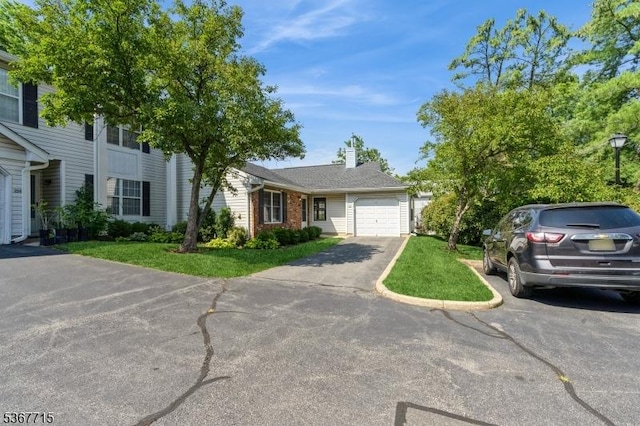 255 Glastonbury Ln, Franklin Twp, NJ 08873 - view of front of home featuring driveway, a garage, brick siding, a chimney, and a front yard