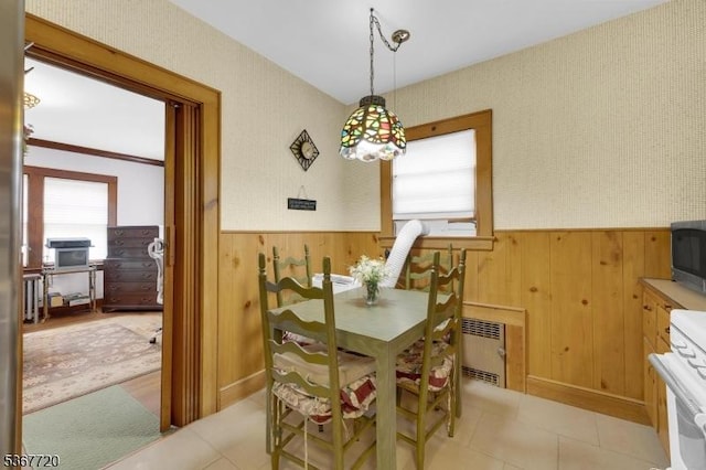 74 Elm Rd, Caldwell Boro Twp, NJ 07006 - dining room featuring wainscoting, wooden walls, light tile patterned floors, and radiator heating unit