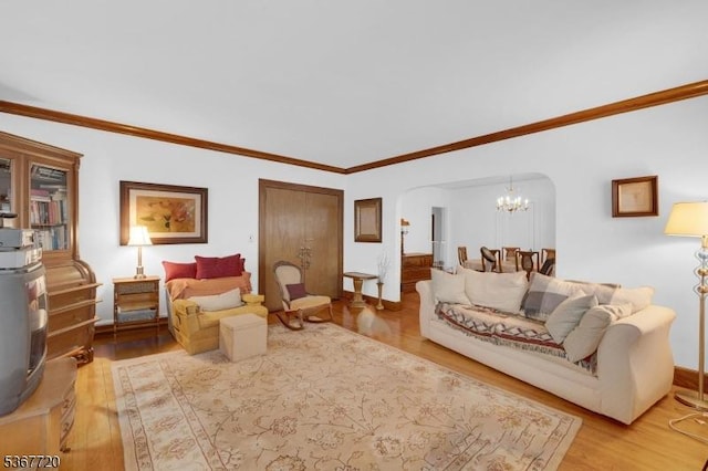 74 Elm Rd, Caldwell Boro Twp, NJ 07006 - living area featuring light wood-style floors, arched walkways, a chandelier, and ornamental molding