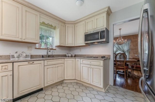 4 Orchid Pl, Clinton Twp, NJ 08833 - kitchen with cream cabinets, stainless steel appliances, a chandelier, and light stone counters