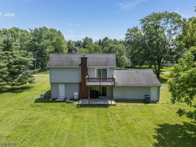 4 Orchid Pl, Clinton Twp, NJ 08833 - back of property with a patio, a yard, a wooden deck, and a chimney