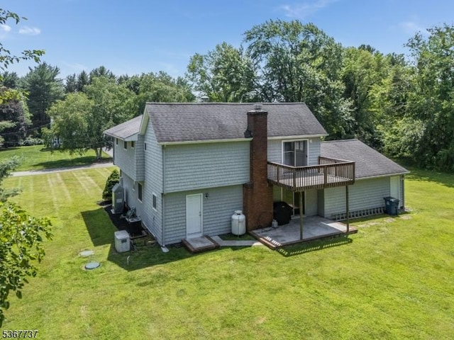 4 Orchid Pl, Clinton Twp, NJ 08833 - back of house with a yard, a wooden deck, roof with shingles, a chimney, and a patio area